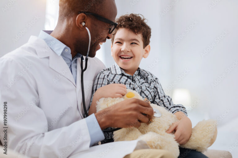 immediate-treatment-enthusiastic-vigorous-male-doctor-sitting-with-boy-while-listening-to-plush-bear-and-talking-stockpack-adobe-stock