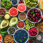 Selection of healthy food. Superfoods, various fruits and assorted berries, nuts and seeds.